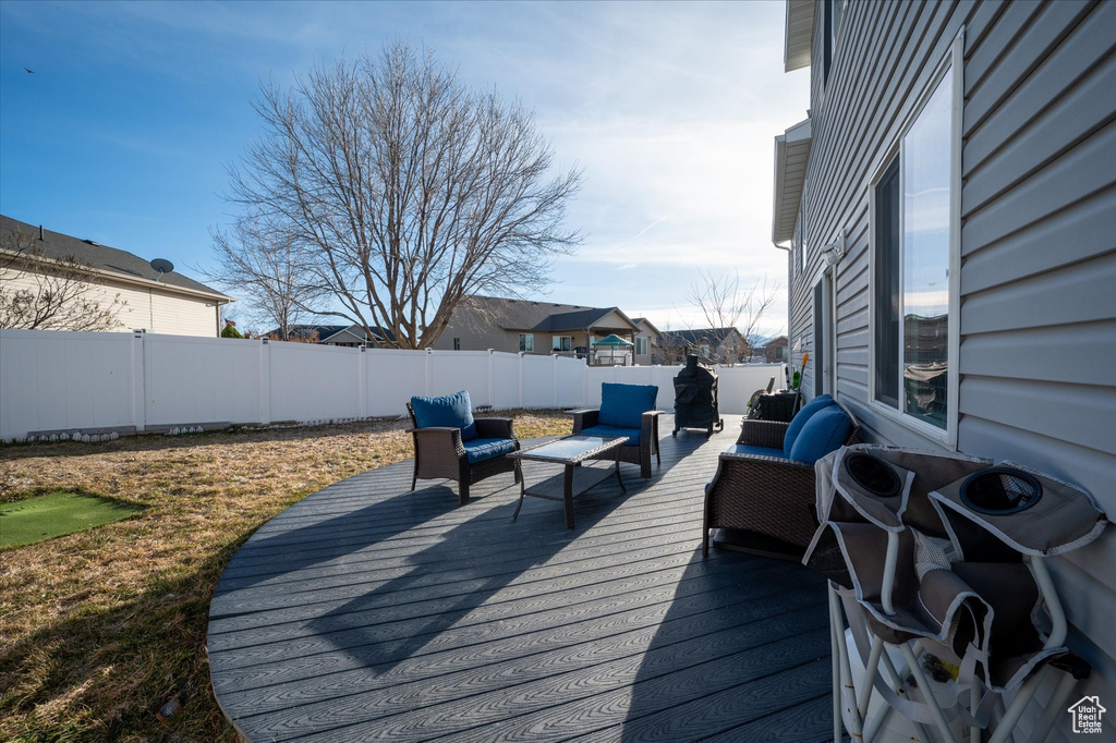 Wooden deck featuring outdoor lounge area
