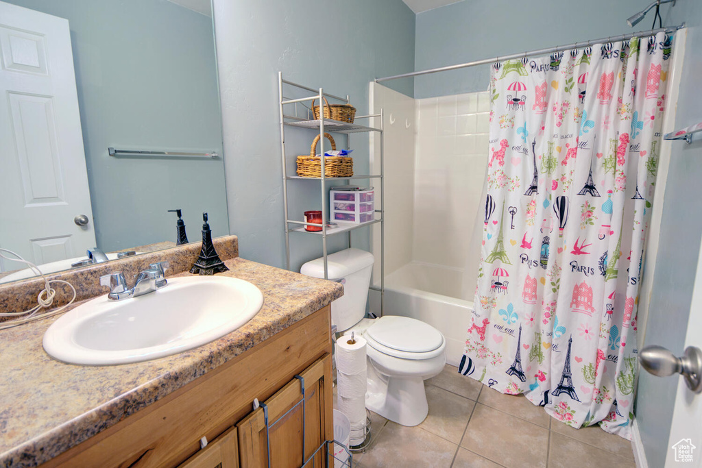 Full bathroom featuring shower / bathtub combination with curtain, vanity with extensive cabinet space, tile flooring, and toilet