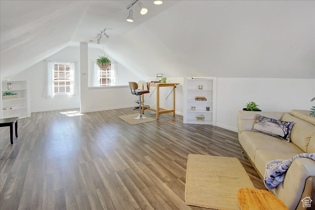 Additional living space featuring vaulted ceiling and hardwood / wood-style flooring