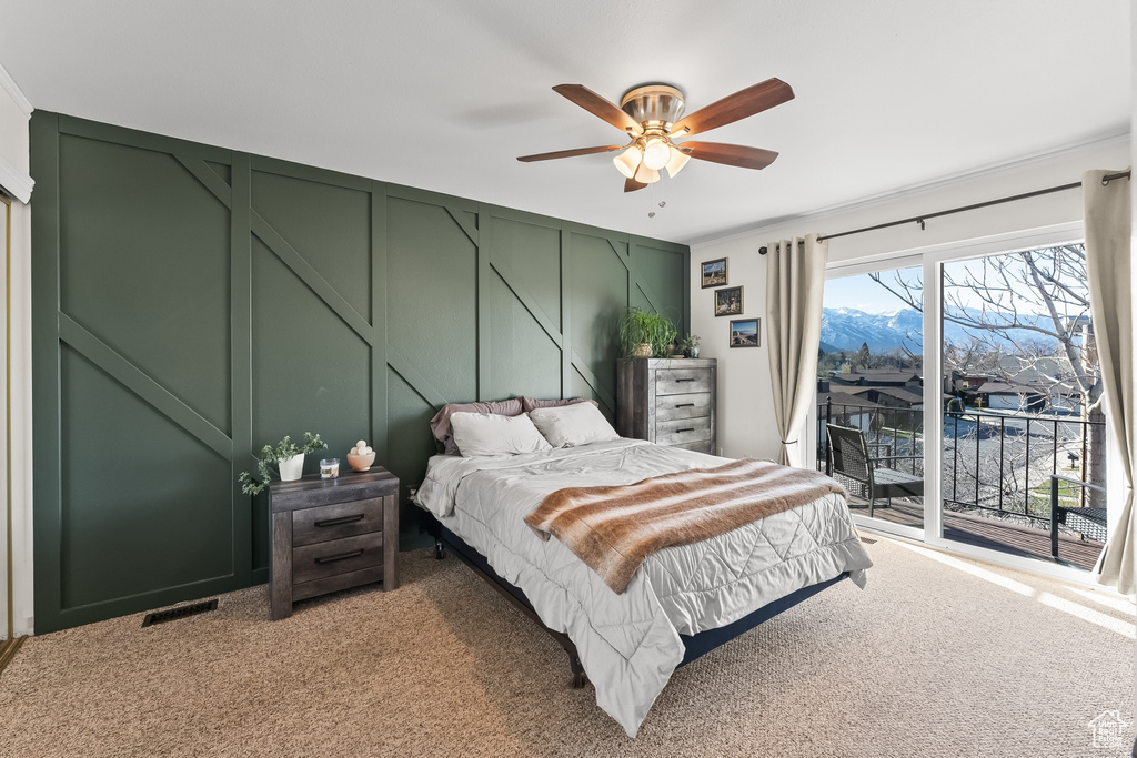 Bedroom featuring ceiling fan, a mountain view, access to exterior, and light colored carpet