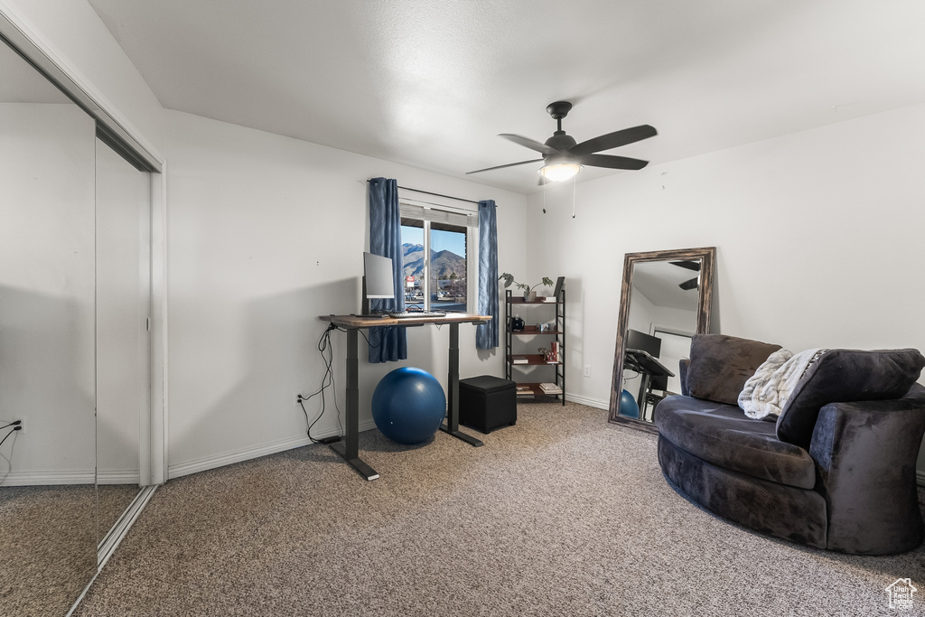 Workout room with light colored carpet and ceiling fan