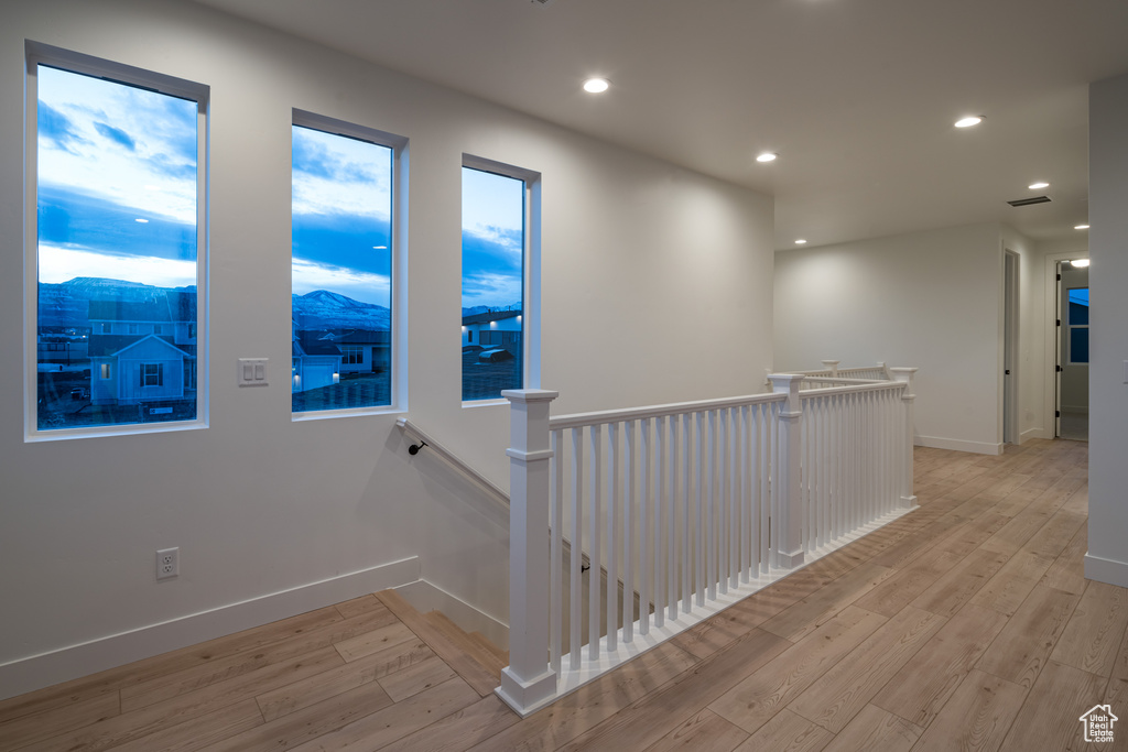 Corridor featuring a mountain view and light hardwood / wood-style floors