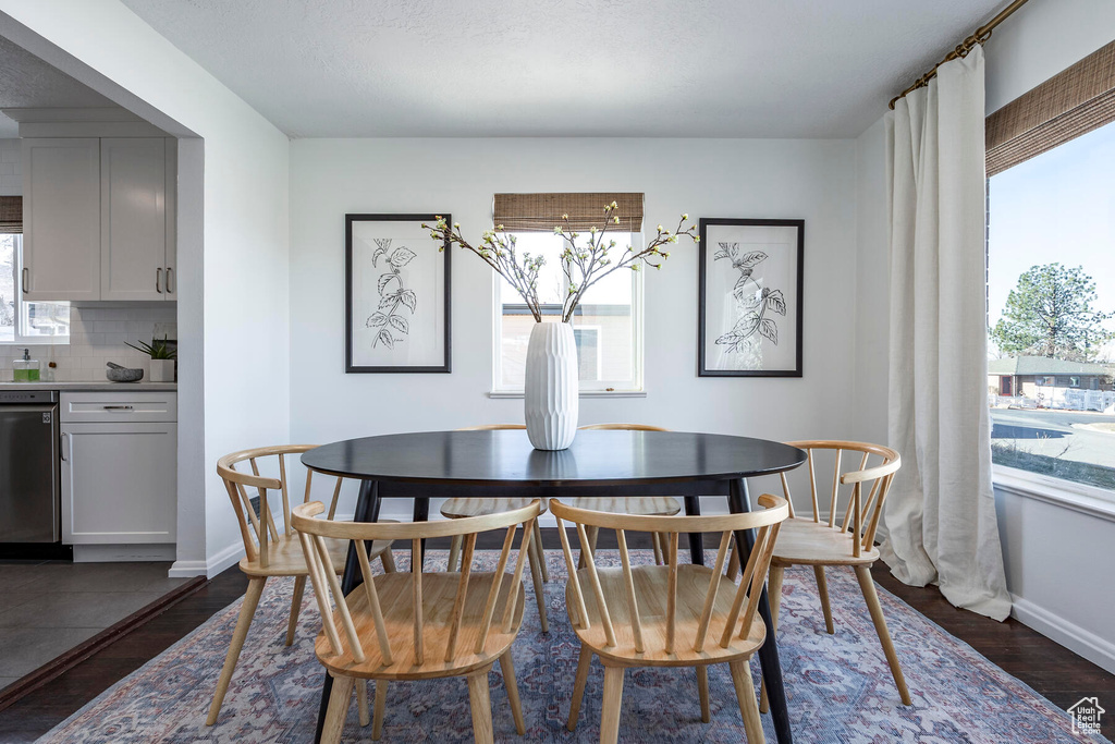 Dining space featuring dark hardwood / wood-style flooring and a wealth of natural light