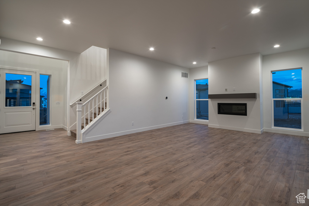 Unfurnished living room with dark hardwood / wood-style flooring