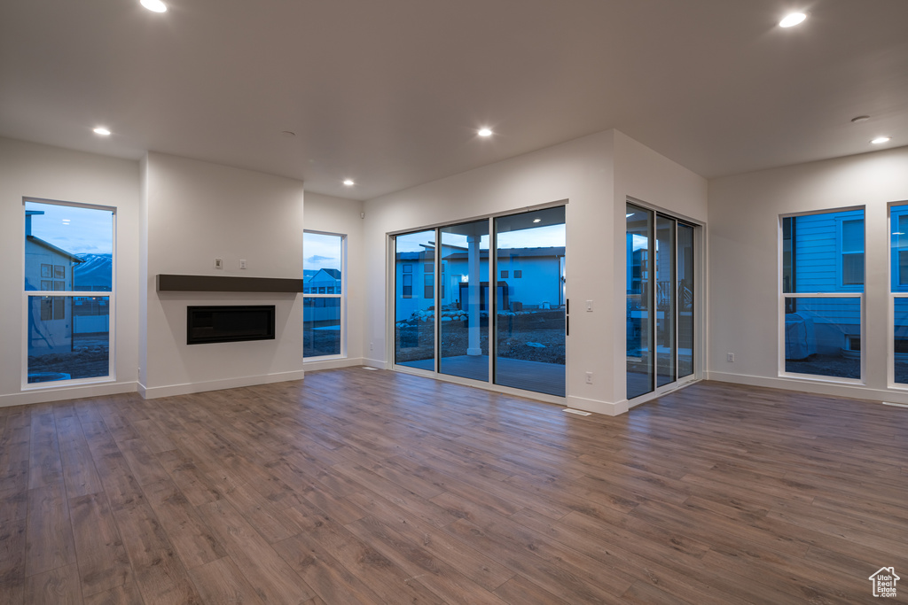 Unfurnished living room with dark hardwood / wood-style flooring