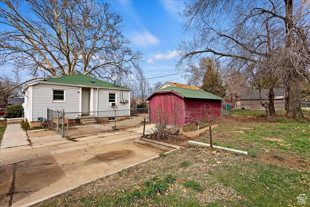 View of yard featuring a storage shed and a patio