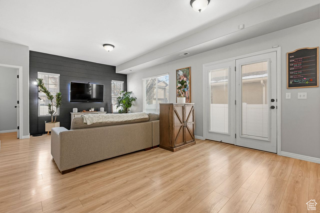 Living room featuring light hardwood / wood-style floors and wood walls