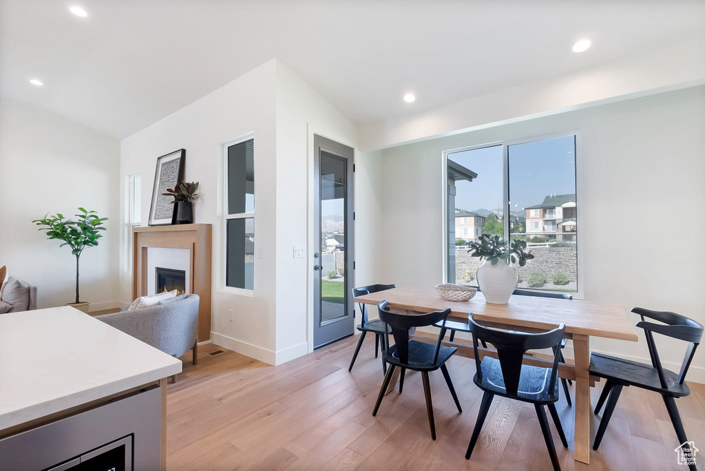 Dining room featuring light hardwood / wood-style floors and vaulted ceiling