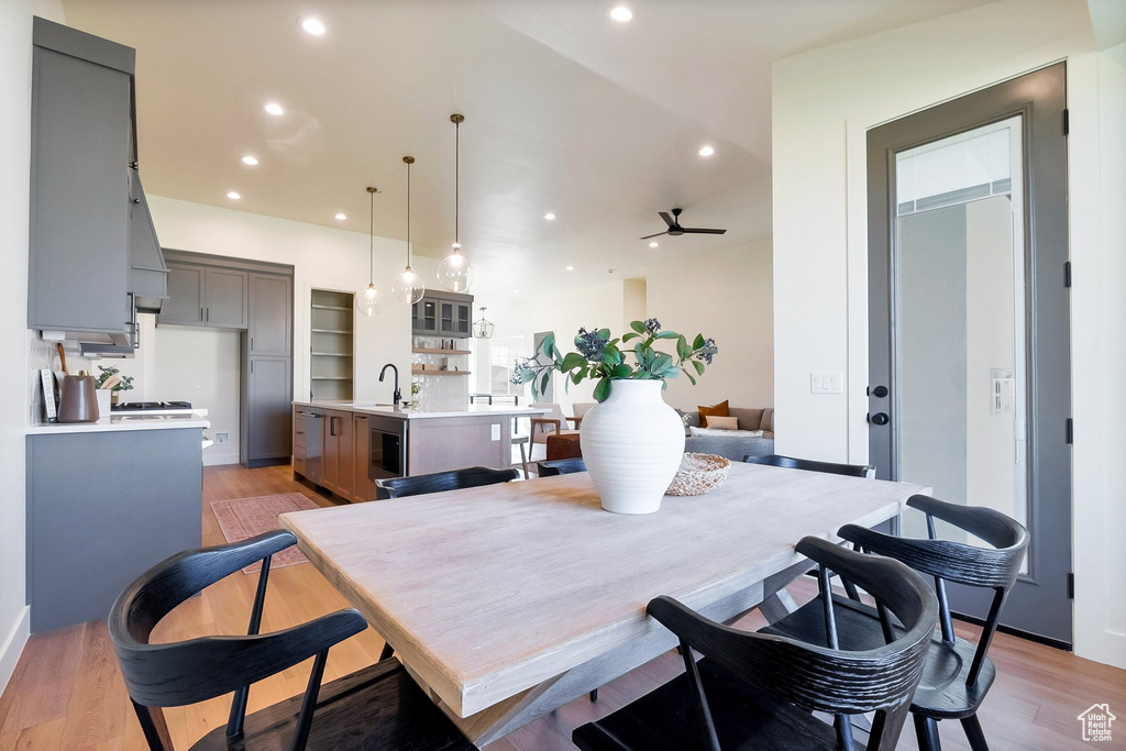 Dining space with sink, ceiling fan, and light hardwood / wood-style floors