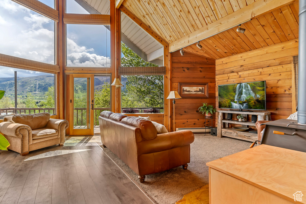 Living room featuring wooden ceiling, french doors, a mountain view, beam ceiling, and dark wood-type flooring