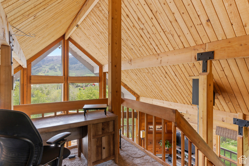 Office area featuring beam ceiling, wooden ceiling, a wealth of natural light, and a mountain view