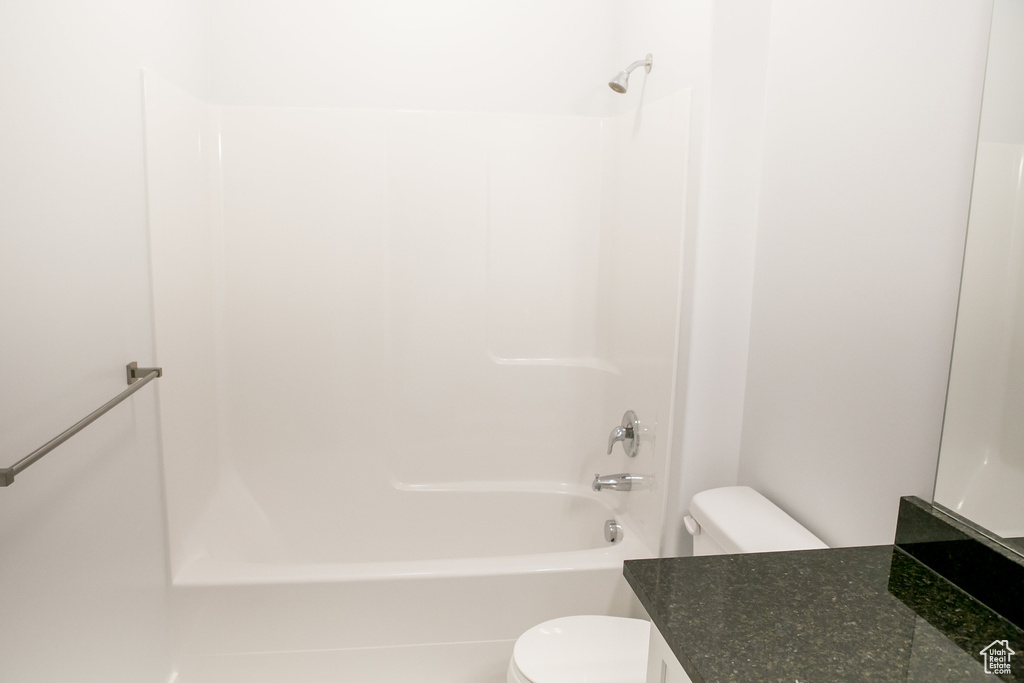 Full bathroom featuring vanity, shower / washtub combination, and toilet