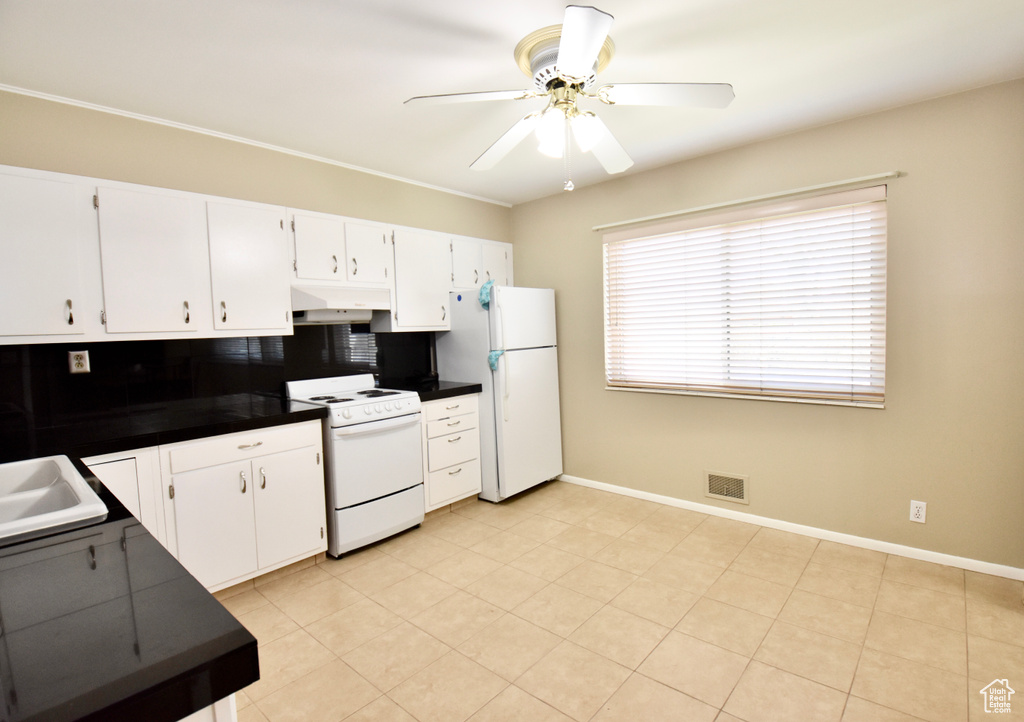 Kitchen featuring backsplash, white cabinets, ceiling fan, light tile floors, and white appliances