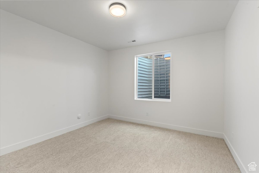 Spare room featuring light colored carpet