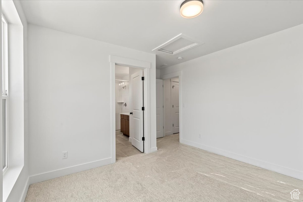 Unfurnished room featuring light colored carpet