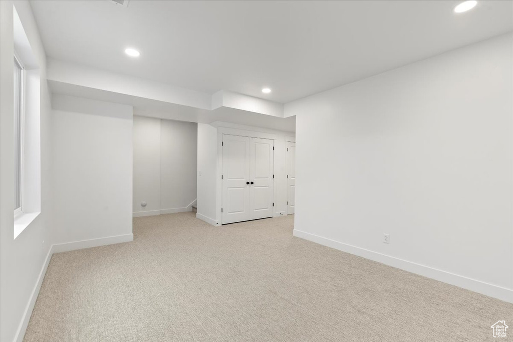 Unfurnished bedroom with a closet and light colored carpet