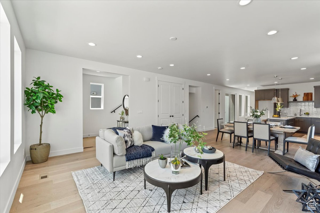 Living room with light hardwood / wood-style floors