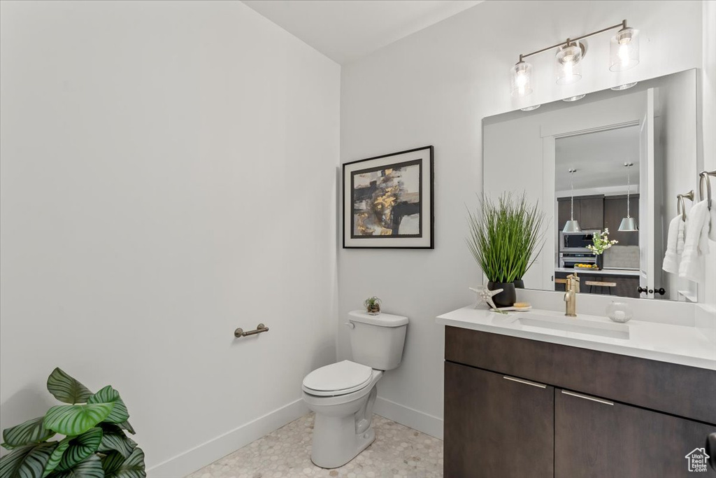 Bathroom featuring vanity, toilet, and tile patterned floors