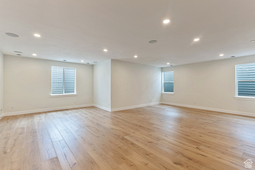 Empty room with light hardwood / wood-style floors