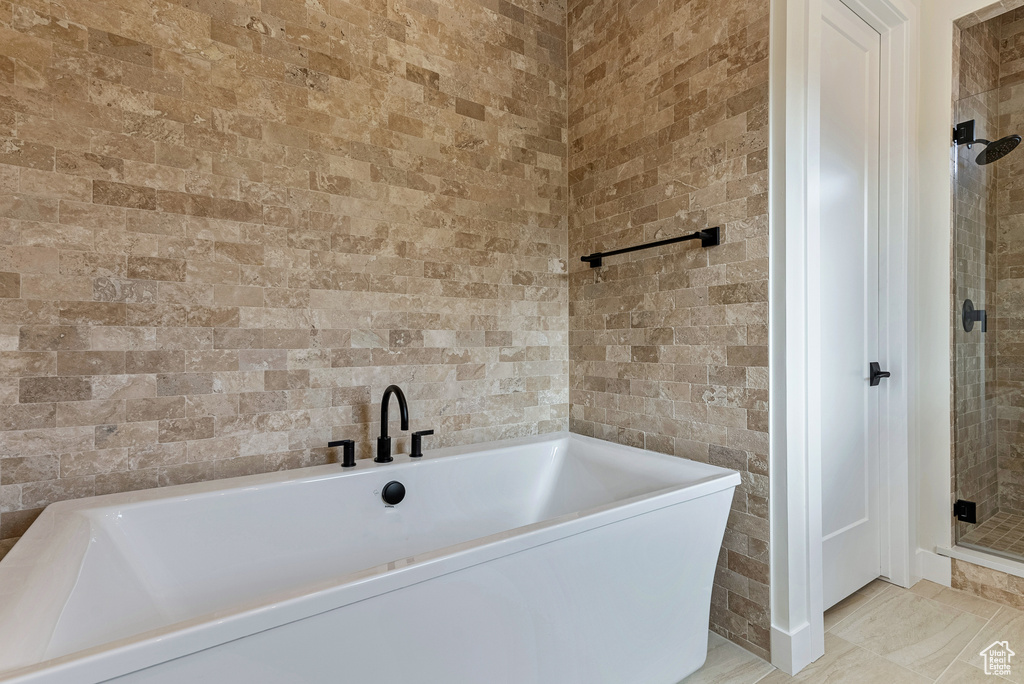 Bathroom featuring tile flooring and a bathing tub