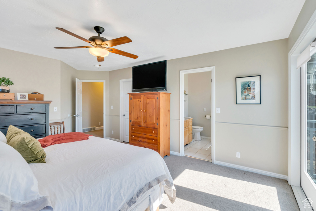 Bedroom featuring ceiling fan, ensuite bathroom, access to exterior, and light tile floors