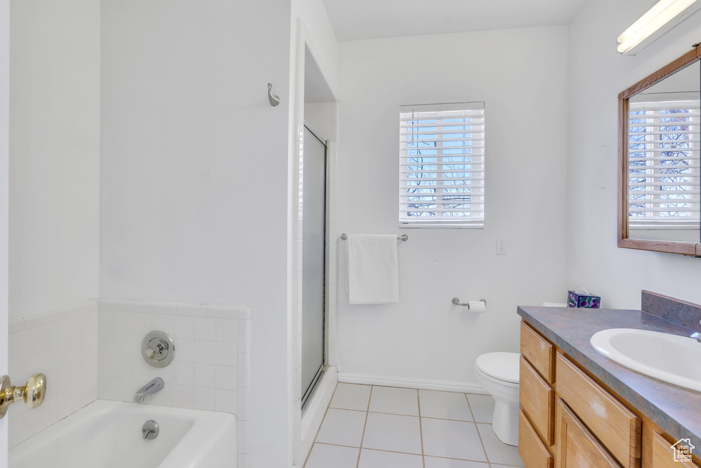Full bathroom with large vanity, toilet, tile floors, and shower with separate bathtub