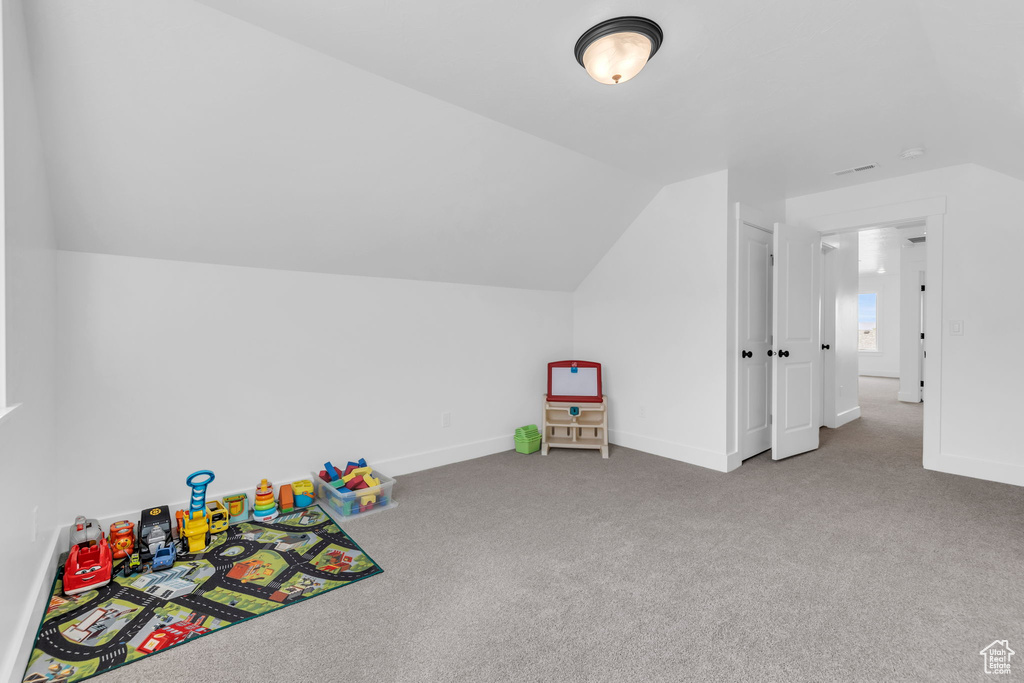 Recreation room with carpet floors and lofted ceiling