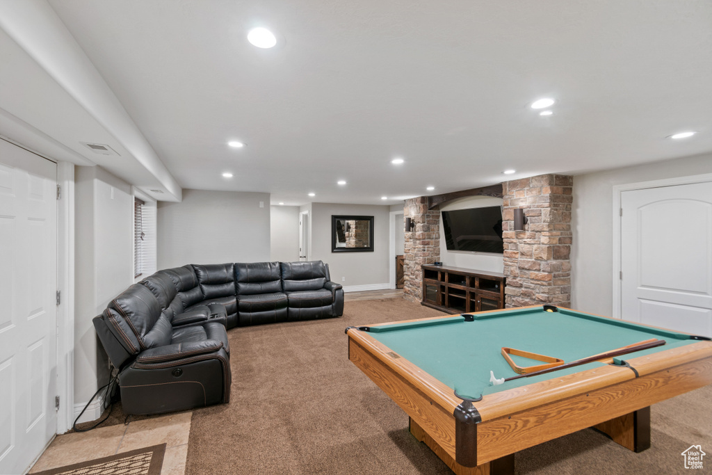 Recreation room featuring billiards, light colored carpet, and a fireplace
