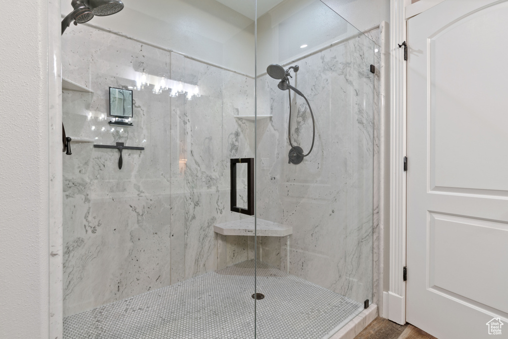 Bathroom with walk in shower and hardwood / wood-style flooring