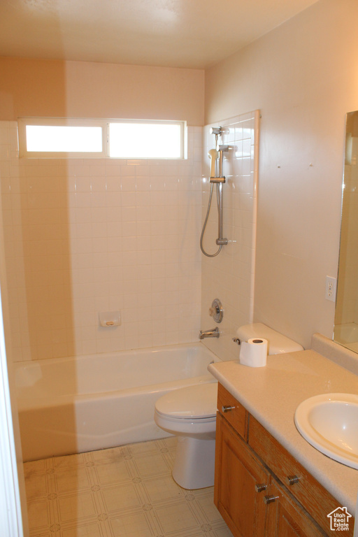 Full bathroom with tile flooring, vanity, toilet, and tiled shower / bath combo
