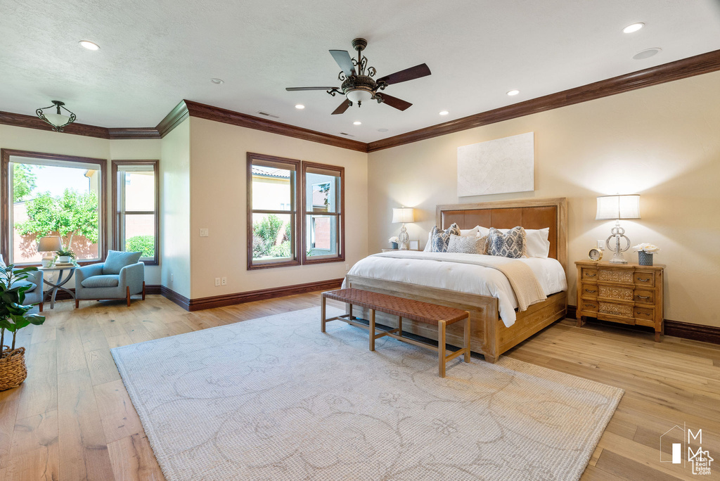 Bedroom featuring crown molding, ceiling fan, and light hardwood / wood-style floors