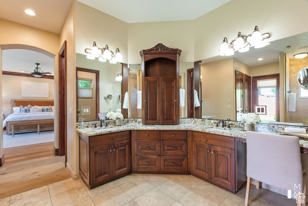 Bathroom featuring ceiling fan, tile floors, and double sink vanity