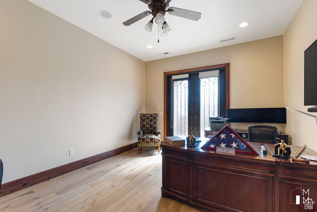 Office area featuring french doors, ceiling fan, and light hardwood / wood-style floors