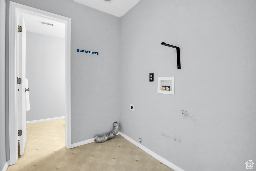 Washroom featuring light hardwood / wood-style floors, electric dryer hookup, gas dryer hookup, and hookup for a washing machine