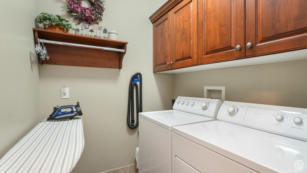 Washroom with independent washer and dryer and cabinets