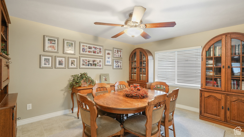 Tiled dining room featuring ceiling fan