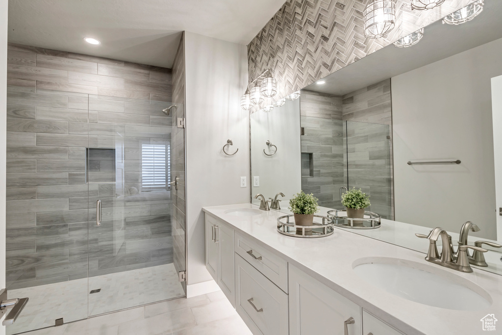 Bathroom with an enclosed shower, tile floors, double sink, and oversized vanity