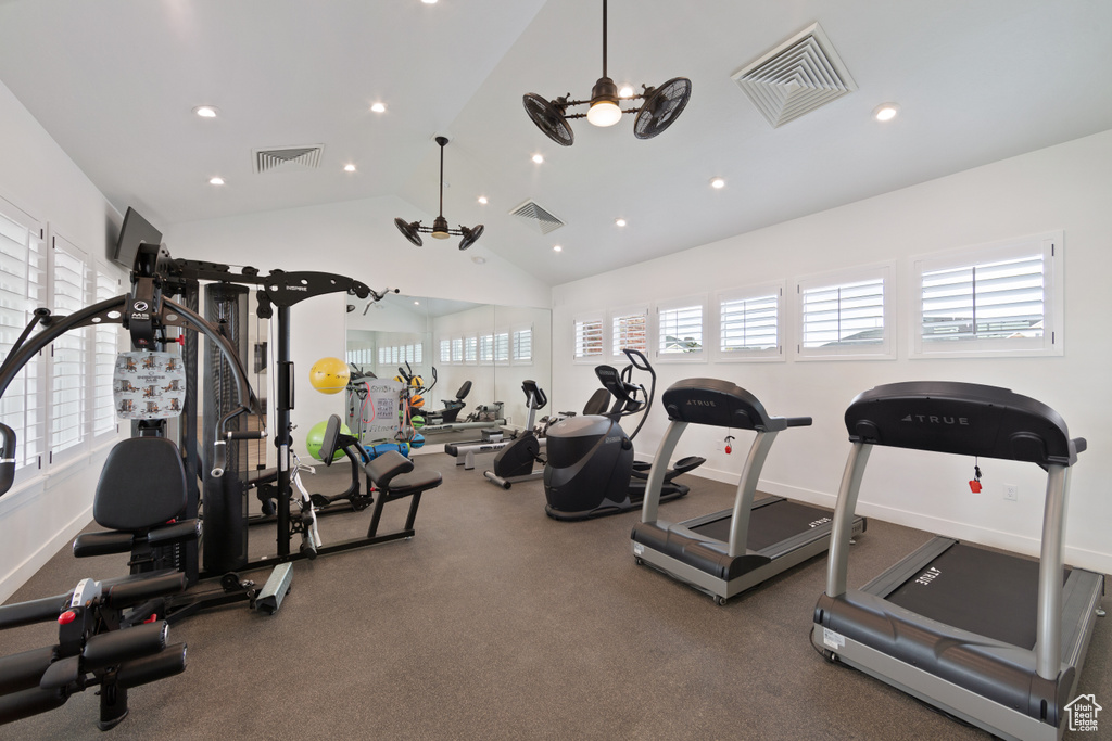 Workout area featuring plenty of natural light, ceiling fan, and vaulted ceiling
