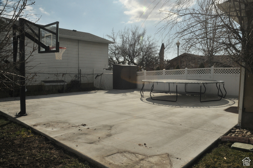 View of patio / terrace featuring a trampoline and basketball court