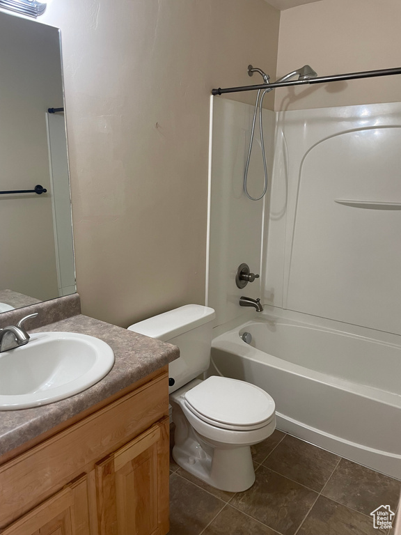 Full bathroom with vanity, toilet, bathtub / shower combination, and tile floors