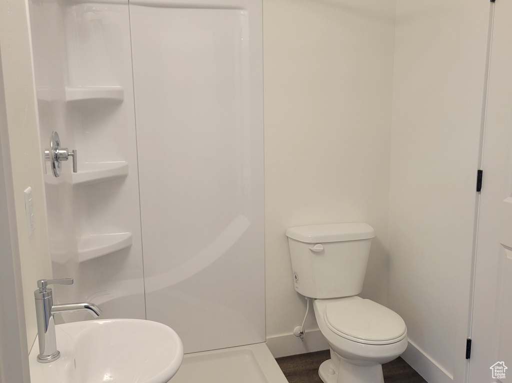 Bathroom featuring a stall shower and wood finished floors