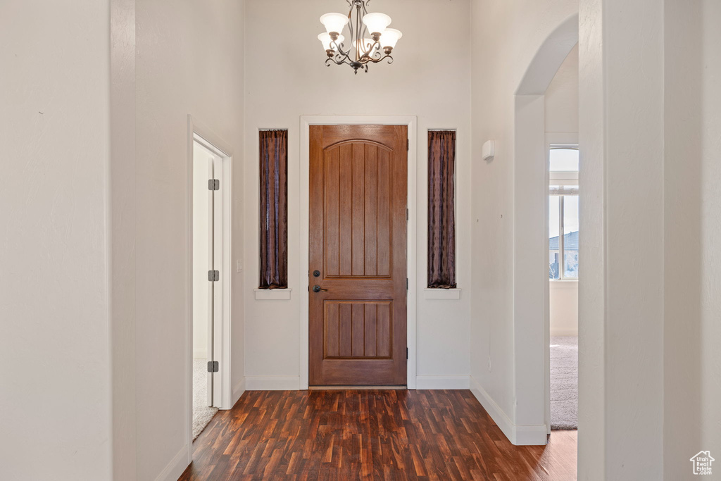 Entrance foyer featuring a chandelier and dark hardwood / wood-style floors