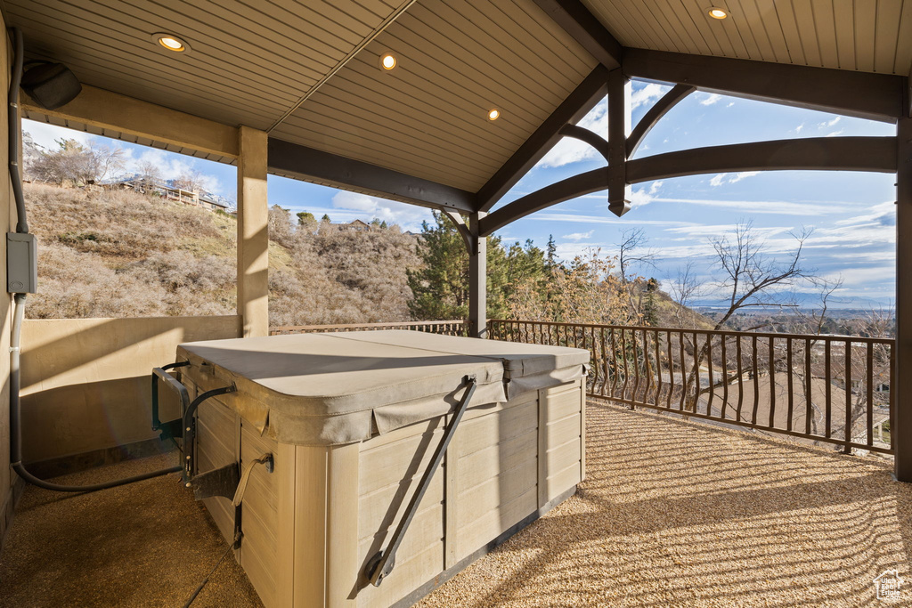 View of patio with a hot tub
