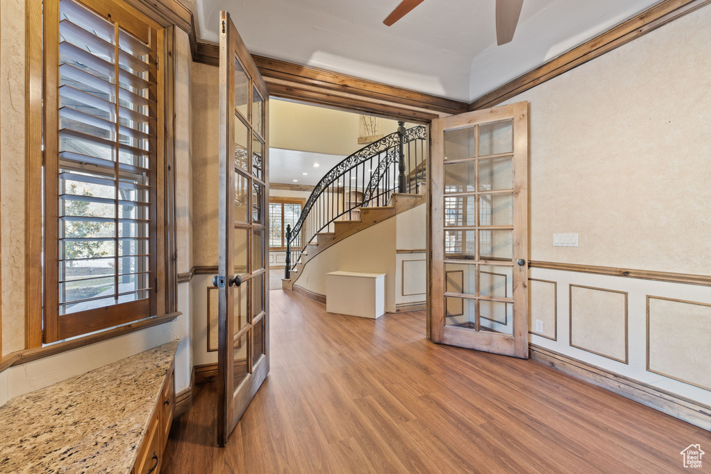 Entryway with french doors, hardwood / wood-style floors, and ceiling fan
