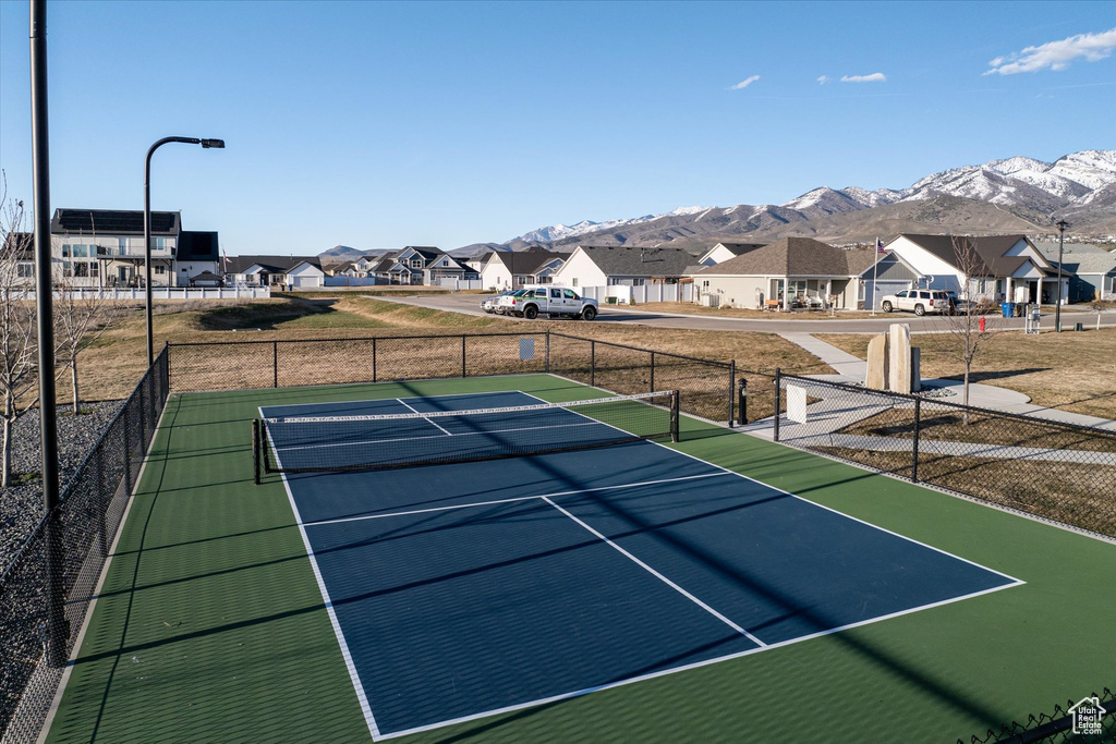 View of tennis court with a mountain view