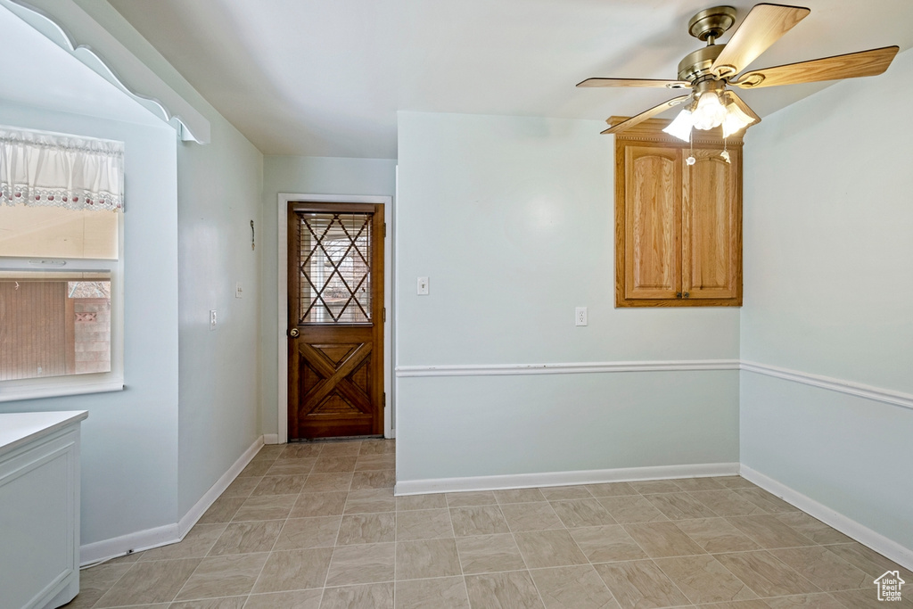 Entryway with ceiling fan and light tile floors