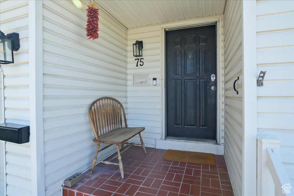 Doorway to property with covered porch