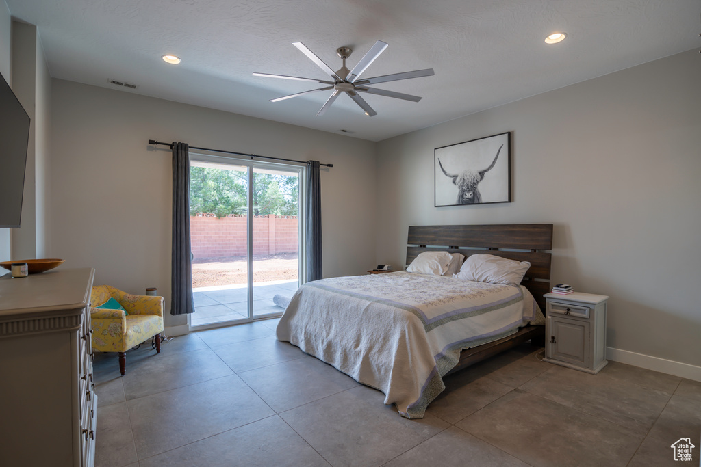Tiled bedroom with access to exterior and ceiling fan
