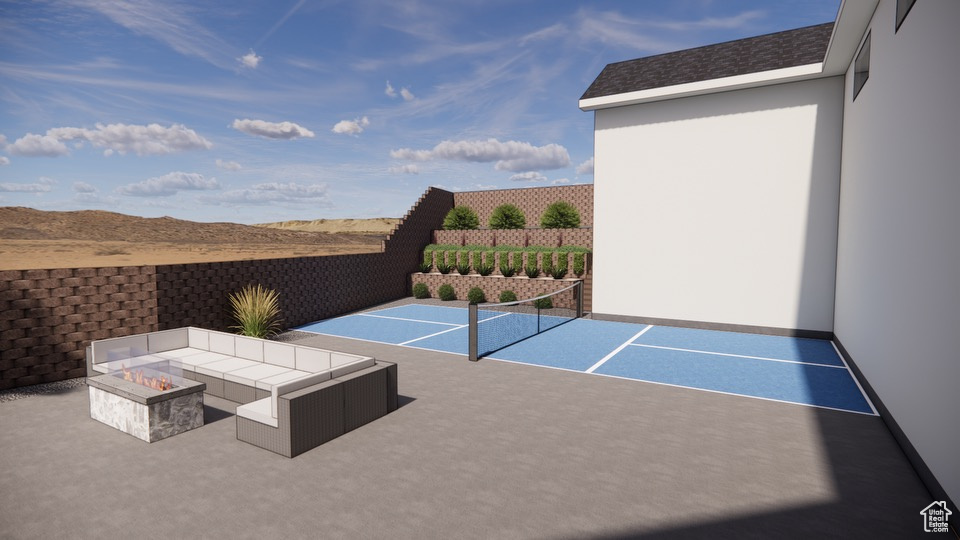 View of tennis court featuring a fire pit