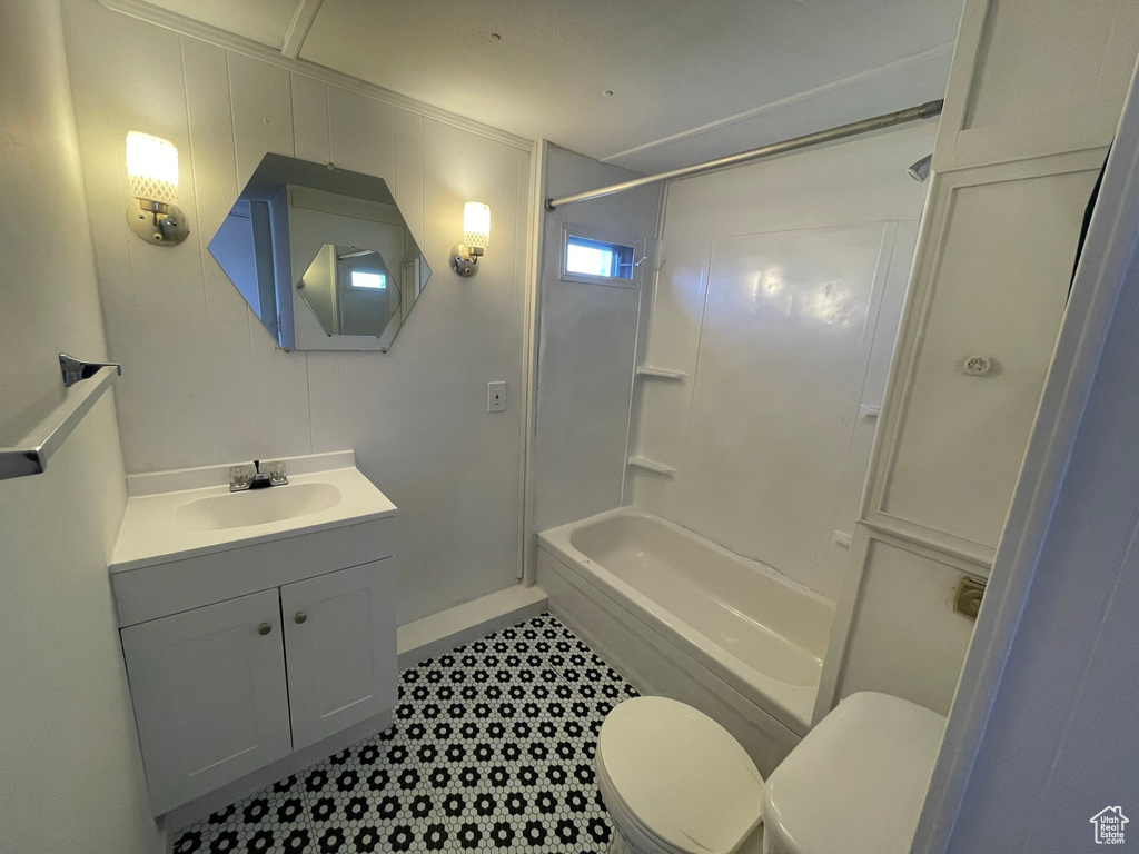 Full bathroom with vanity, toilet, tile flooring, and bathing tub / shower combination